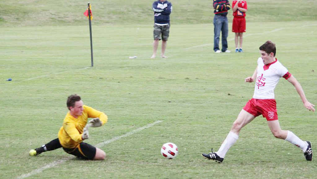 DETERMINED ATTACK: Skilful Ipswich Grammar School goal scorer Tom Webster challenges the BBC goalkeeper during last weekend’s GPS match. DETERMINED ATTACK: Skilful Ipswich Grammar School goal scorer Tom Webster challenges the BBC goalkeeper during last weekend’s GPS match.